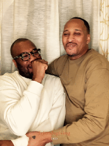 A laughing couple at a Friendsgiving photobooth event