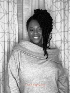 A confident and happy woman in a Friendsgiving party photobooth